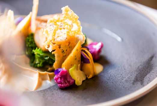 Close up of a cod main dish with green vegetables