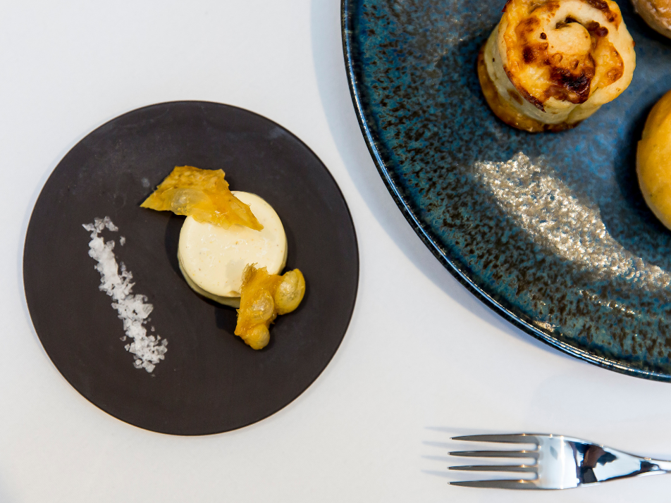 Butter with chicken skin and salt served on a charcoal stone plate