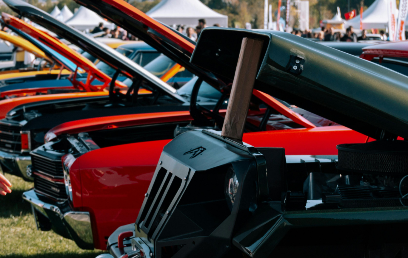 Row of classic cars all with their bonnet open
