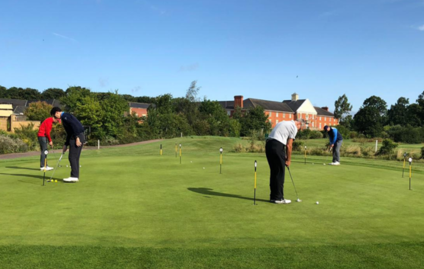 Golfer lining up a putt shot to the flag