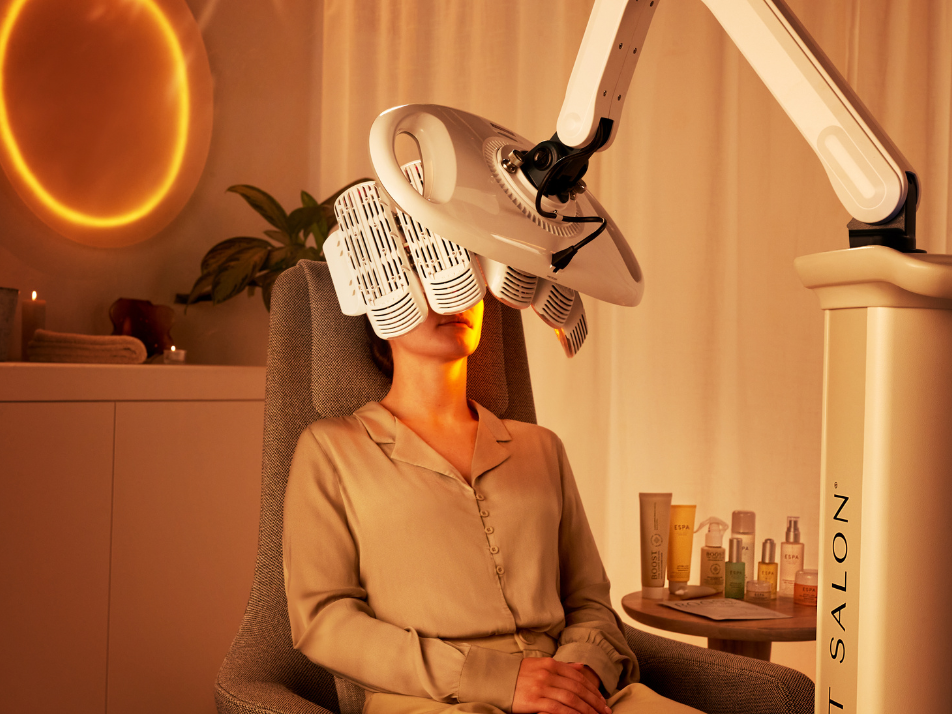 A lady sitting in a chair receiving a Light Salon facial exposure treatment