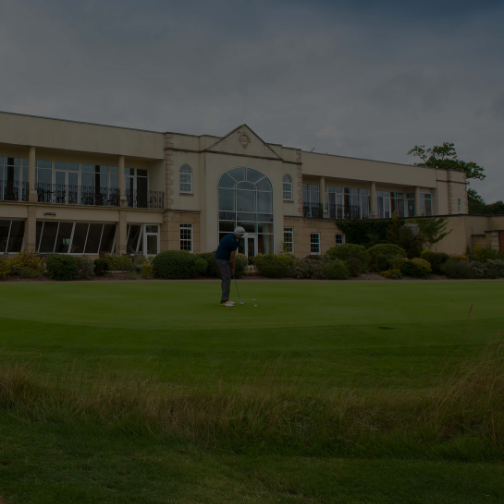 Golf outside a golf clubhouse on a putting green