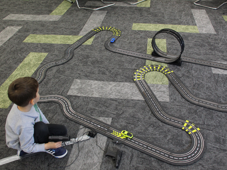 A child playing with an rc car course