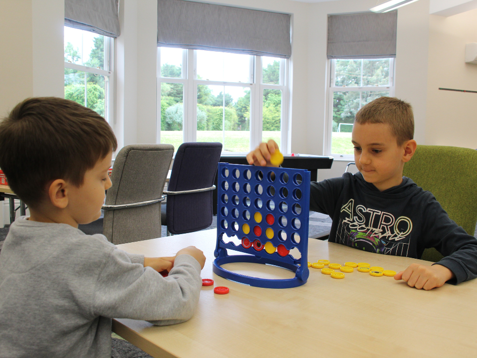 Two kids playing connect four