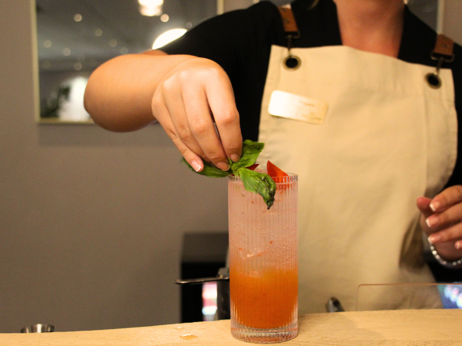 A bartender garnishing a strawberry cocktail at the Nova Bar