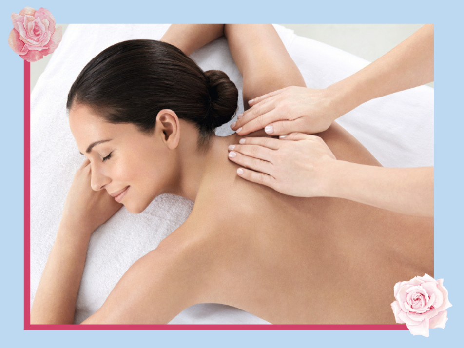 Lady laying on a massage bed receiving a back massage