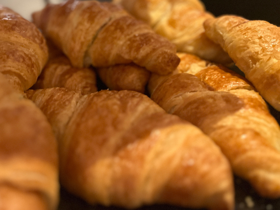 A close up photo of golden brown croissants