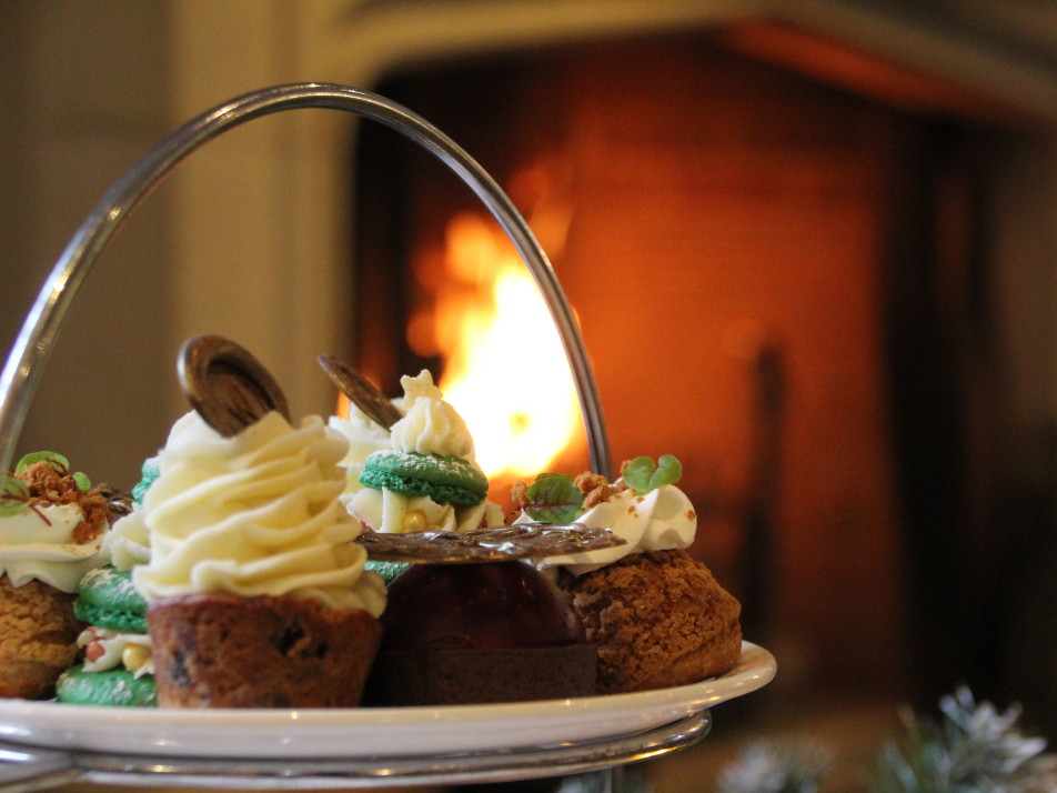 A festive afternoon tea sitting in front of a roaring fireplace