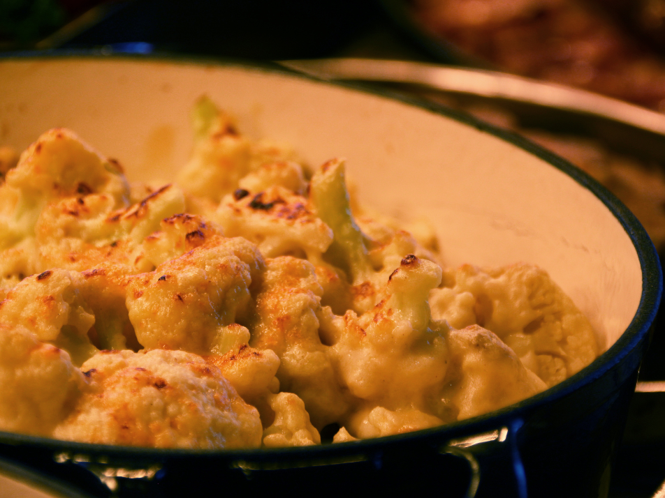 Crispy golden coated cauliflower cheese in a ceramic serving bowl